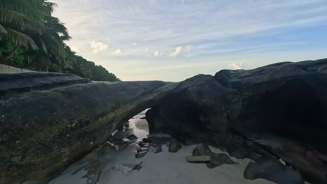 Serene Tropical Beach and Turquoise Ocean Pan Shot at Sunset