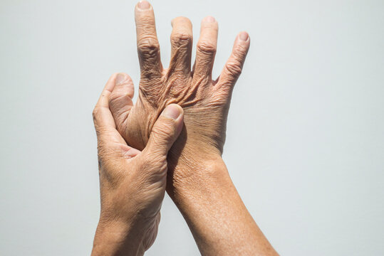 Hands of senior people on white background. Health care concept.