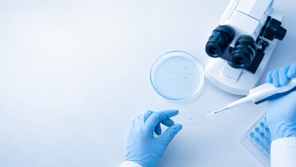 Fototapeta premium Scientist using pipette to transfer liquid into petri dish in laboratory. Medical researcher conducting scientific experiment with microscope. Biology analysis and healthcare study concept.