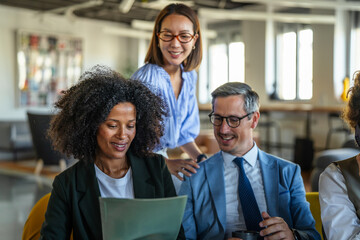 Diverse business professionals discussing project during office meeting