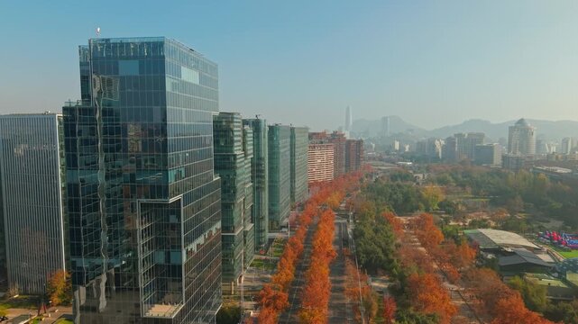 Nueva Las Condes buildings and colorful trees of Araucano Park, Santiago, Chile. Aerial