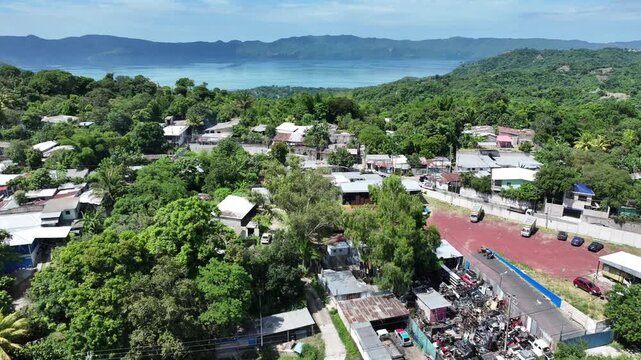 Drone Ascending Above Green Hills Revealing Lake Ilopango El Salvador