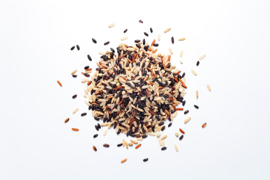 pile of seven different organic rice grains on white backgroiund, Healthy food concept, top view