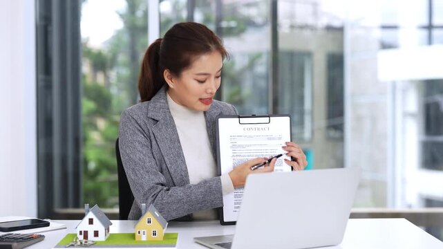 Asia business woman professional real estate sale agent talking explaining business contracts, lease agreements, loans and banks for new home purchase  via video call.