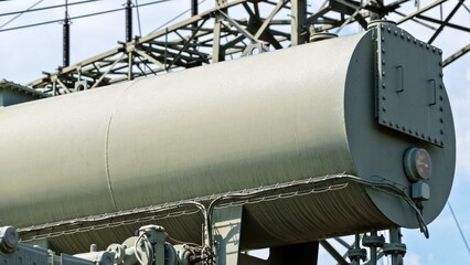Naklejka premium Close-Up of Large Electrical Transformer Tank and Components