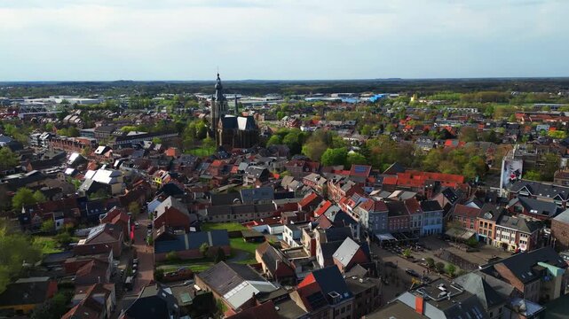Aerial drone footage flying over the historic town of Aarschot in Belgium, revealing the cityscape and church