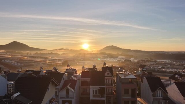 Aerial landscape of morning mist over houses at sunrise, Da lat