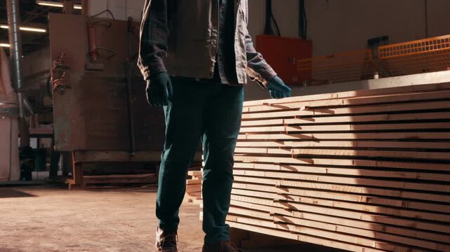 Carpentry, hands or wood inspection in factory for lumber project, surface quality or inventory count. Carpenter, person and gloves with material evaluation for timber defect, backlog and stock check