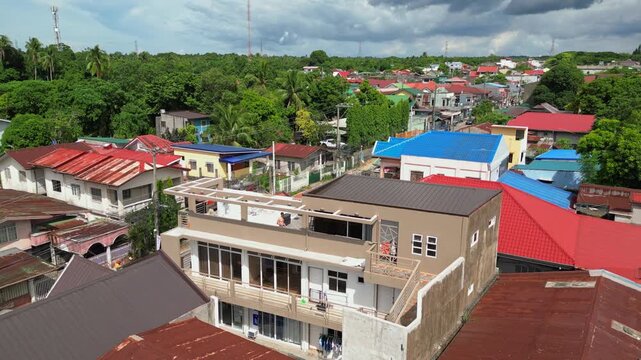 Static drone frame capturing CJDC Building and surrounding urban-rural structures in Barangay Poblacion III Alfonso Cavite Philippines during clear daylight.