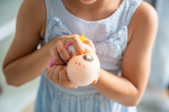Hands squeeze a soft squishy stress relief toy during sensory play. Tactile interaction promotes relaxation, emotional regulation and stress reduction.