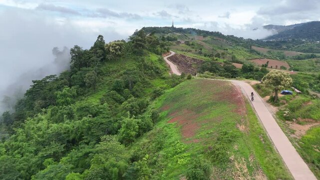 An aerial video showing stunning mountain views in Thailand, featuring a paved road and morning mist.
