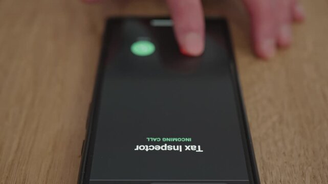 Unwanted call from tax inspector on mobile phone screen