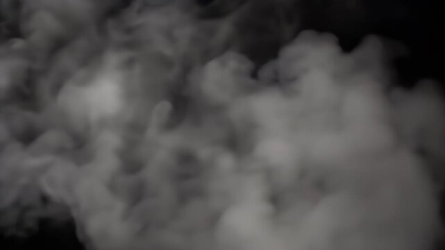 Wisps of white smoke drift across a dark background.