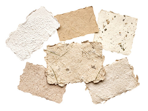 Assortment of handmade paper sheets with natural textures, visible fibers.