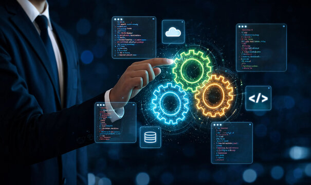 Businessman touching digital gear icons and programming code interface for software development process in a dark futuristic office environment with blue light