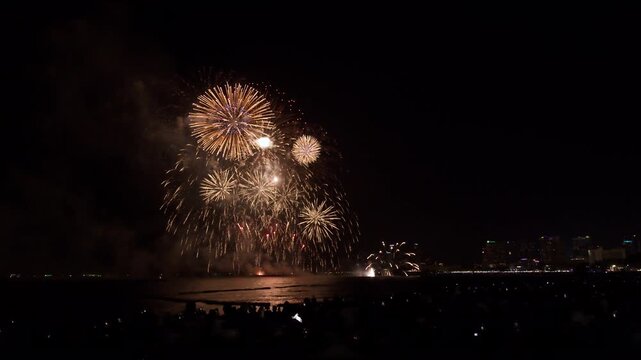 Golden Fireworks Exploding Over The Ocean Dark Night Horizon In Pattaya Chon Buri Thailand