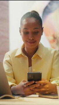 360 Degree Vertical Screen. Black Woman Works on Laptop Computer at Office Desk, Typing Emails, Browsing Internet and Handling Daily Business Tasks Productively. Cinematic Arc Tracking Shot.