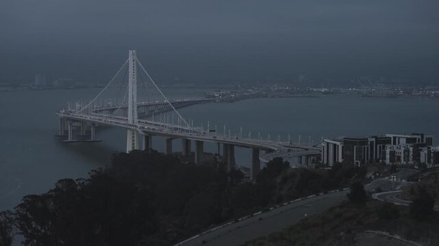 Cable-Stayed Bridge Seen From Wooded Island at Dusk - Cinematic Drone Shot With Stormy Sky