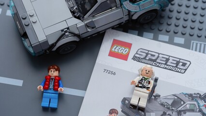 Obraz premium Tambov, Russian Federation - June 20, 2026 Lego Speed Champions Back to the Future time machine car with Marty McFly and Doc Brown minifigures and instruction booklet