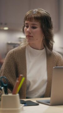 360 Degree Vertical Screen. Caucasian Woman Uses Laptop Computer at Modern Office Desk, Typing Emails, Handling Everyday Business Tasks, Browsing Internet and Staying Productive at Work. Tracking Shot
