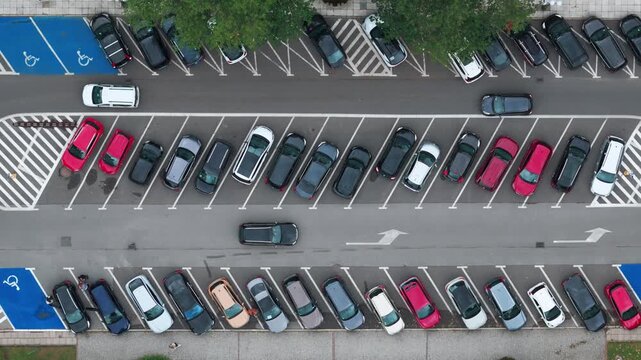 Aerial top down view of cars in a crowded parking lot