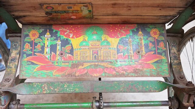Close-up of a hand-painted Taj Mahal illustration on a traditional rickshaw plate in Dhaka, Bangladesh. Documents iconic UNESCO intangible cultural heritage art and South Asian crafts.