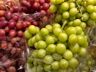 Fresh green and red grapes at market © brostock