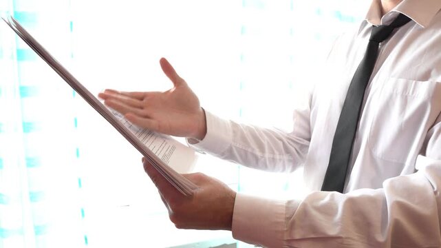 Businessman looking through documents in the office, office worker