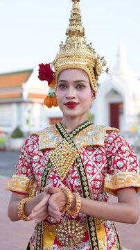 Traditional Thai Khon Dancer Performing Wai Greeting at Historic Temple