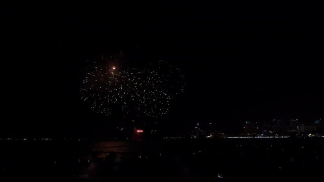 Colorful Firework Explosions Lighting Up The Night Sky Over The Ocean Coastline In Pattaya Chon Buri Thailand