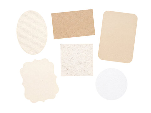 Assorted blank textured paper cutouts in diverse shapes, neutral and light tones, isolated on a transparent background.