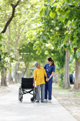Fototapeta premium Caregiver assisting senior woman walking outdoors in a park, providing support and companionship, promoting active retirement and rehabilitation in nursing care