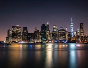 Obraz premium A nighttime cityscape with a body of water in the foreground