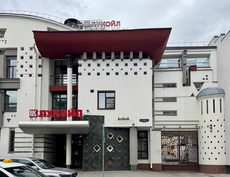 Russia Nizhny Novgorod 28 june 2026 lukoil building entrance signboard on urban street scene with modern concrete and metal architecture in frontal view, white and red colors