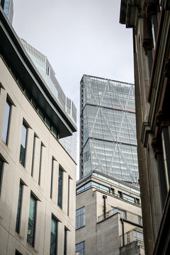 Modern Glass Office Tower Between Historic Buildings in Urban Financial District