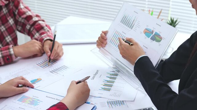 Business team analyzing financial charts and business data during a corporate meeting. Teamwork, strategy, analytics, investment, growth, finance, KPI, modern office, 4K.