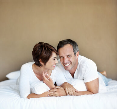 Happy, morning and relax with couple in bedroom for romance, valentines day and marriage. Portrait, getaway and care with man and woman in home or staycation for anniversary retreat and love