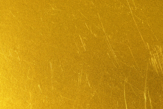 gold background, texture with metallic shine and scratch patterns