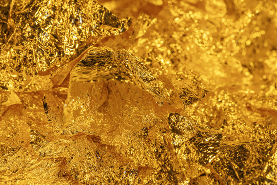 textured gold foil shimmering with metallic light