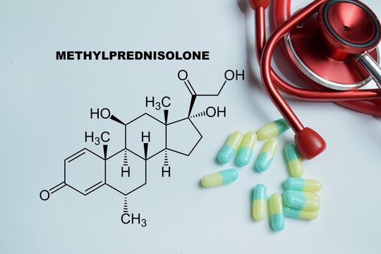 Concept of methylprednisolone corticosteroid write on book isolated on Wooden Table. For inflammation management and autoimmune disease treatment