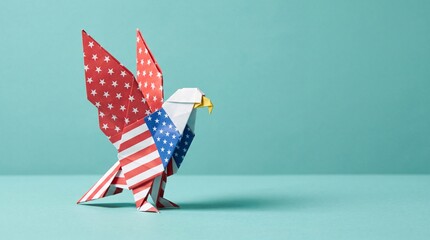 Patriotic origami bald eagle folded from American flag patterned paper standing on a blue studio surface celebrating 4th of July Independence Day holiday theme