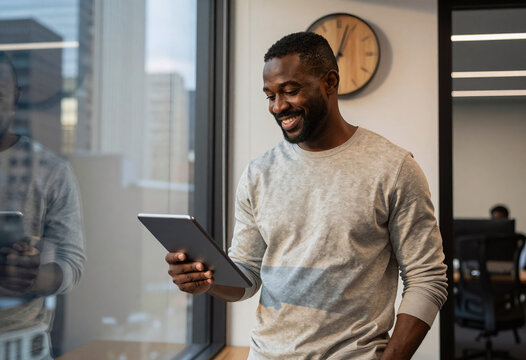 African American Entrepreneur Smiling with Tablet in Modern Office