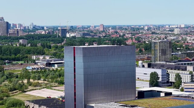 Aerial of data center Amsterdam with the Amsterdam skyline in the background, featuring highways, offices, and urban infrastructure.