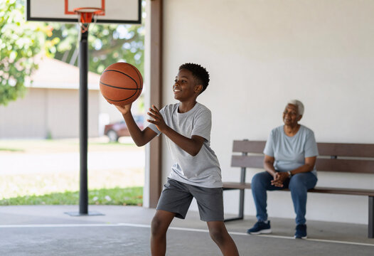 African American boy plays basketball, grandma watches