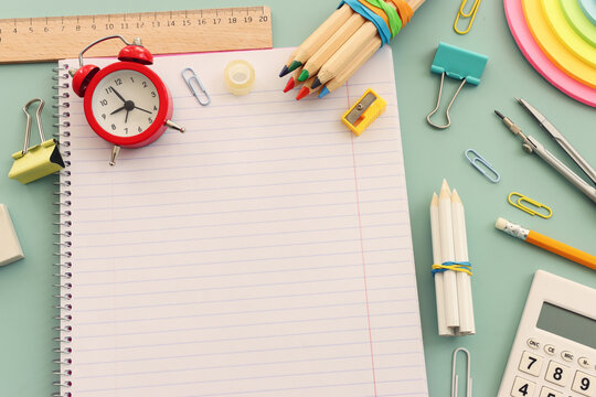 Back to school concept over pastel background. Top view