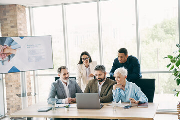 Business professionals discussing strategies collaboratively in an elegant office environment with...