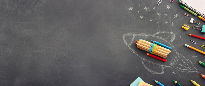 Back to school concept over classroom blackboard. Top view