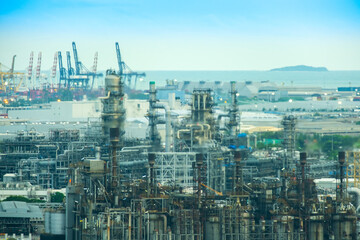 Fototapeta premium A detailed view of a sprawling industrial oil refinery complex with towering chimneys, pipes, and metal structures, concept showcasing the scale of energy production and industrial infrastructure 