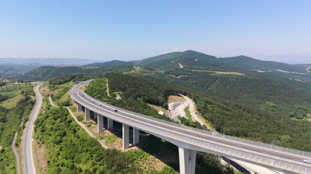 Drone approaches Črni Kal Viaduct as traffic moves across the bridge.