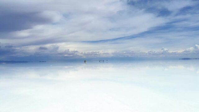 Salar de Uyuni Salt Flat Mirror Effect with Distant Vehicle and People, Bolivia